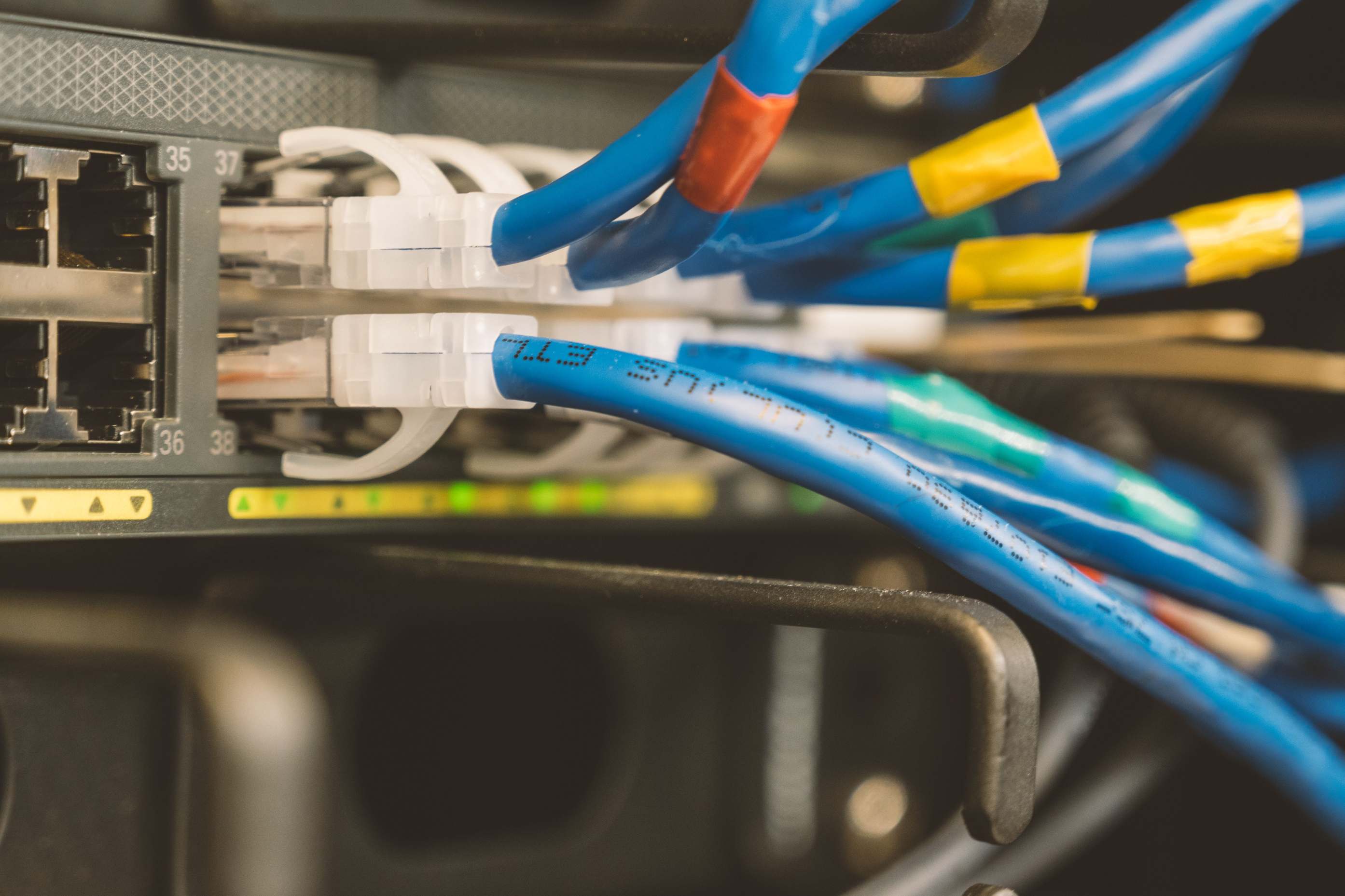 Network switch and blue ethernet cable connected to system for maintenance